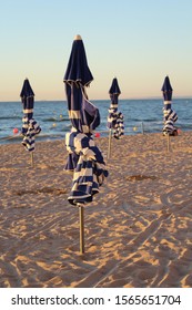 Beach umbrellas at Cabourg beach at evening time