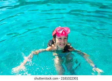 Beach Vacation Fun 9 Year Old Girl Wearing A Snorkel Scuba Mask Making A Goofy Face While Swimming In Ocean Water. Funny Face, Wow Emotions. Summer Vacation Concept