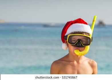 Beach Vacation Fun Boy Wearing A Snorkel Scuba Mask And Santa Claus Hat.