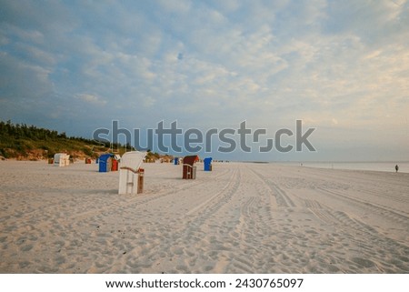  Beach Vacation on the North Sea. Beach baskets on the sea coast . Beach cabins on white sand. Beaches of the Frisian Islands in Germany. Sea summer mood. 