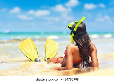 Beach vacation snorkel girl snorkeling with mask and fins. Bikini woman relaxing on summer holidays lying down in water after snorkelling with snorkel tuba and flippers sun tanning. - Powered by Shutterstock