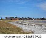 A beach view with the small town of Lockeport, Nova Scotia in view.