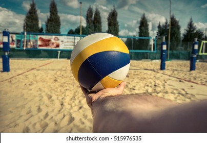 Beach Volleyball ball in hand before start the game under sunlight.