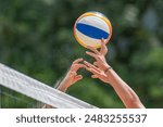 Beach volleyball game with hands and net