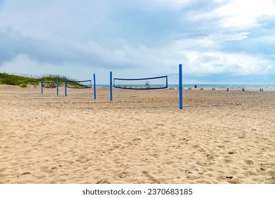 Beach volleyball net on sandy terrain of North Carolina beach on overcast summer day - Powered by Shutterstock