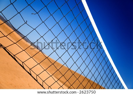 Beach volleyball net with dune in the background