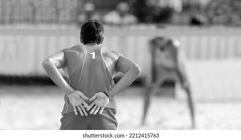 A Beach Volleyball Player Is Relaying Hand Signals To His Team Mate Black And White