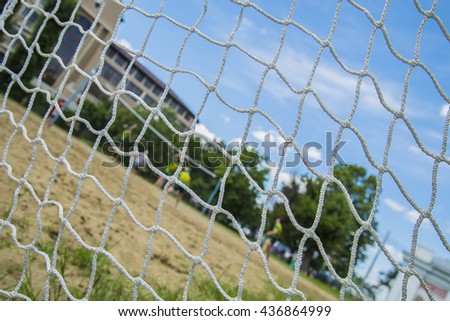 Beach volleyball players through the net. Rio games.
