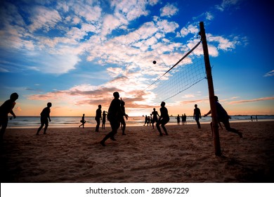 Beach volleyball silhouette at sunset