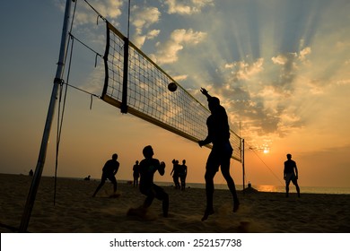 Beach volleyball silhouette at sunset , motion blurred