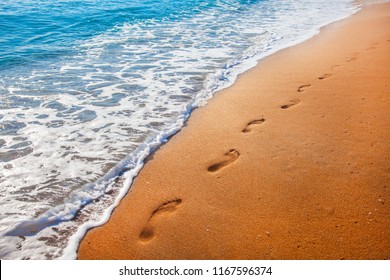 Beach, Wave And Footprints At Sunset Time