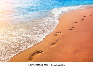 Beach, Wave And Footprints At Sunset Time