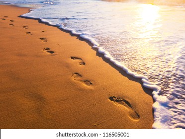 Beach, Wave And Footsteps At Sunset Time