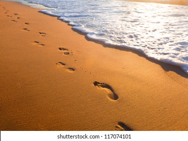 beach, wave and footsteps at sunset time - Powered by Shutterstock