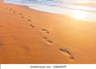 Beach, Wave And Footsteps At Sunset Time