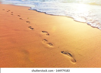 Beach, Wave And Footsteps At Sunset Time