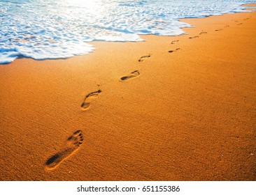 Beach, Wave And Footsteps At Sunset Time