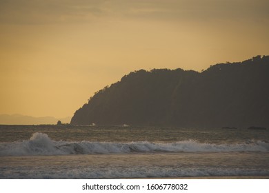 Beach with waves in the sunset