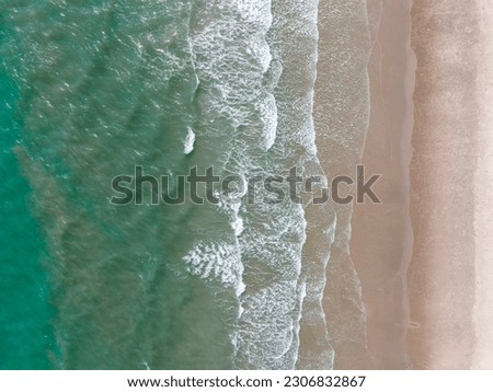 Similar – Luftaufnahme Panoramadrohne Blick auf den blauen Ozean Wellen, die am Sandstrand in Portugal erdrücken.