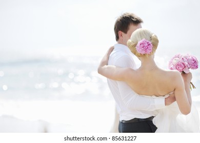 Beach wedding: bride and groom by the sea