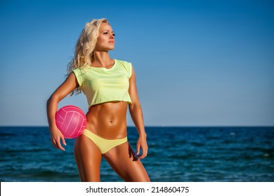 Beach Woman In Bikini Holding A Volleyball