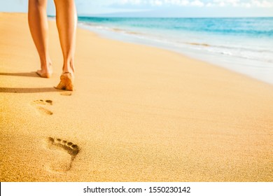 Beach woman legs feet walking barefoot on sand leaving footprints on golden sand in sunset. Vacation travel freedom people relaxing in summer. - Powered by Shutterstock