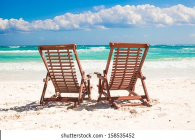 Beach wooden chairs for vacations and relax on tropical white sand beach in Tulum, Mexico - Shutterstock ID 158535452