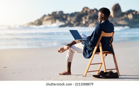 Beach, work and black man reading an email on a laptop with 5g internet while working by ocean. Relax, smile and happy African businessman doing remote business on a chair at the beach with computer - Powered by Shutterstock