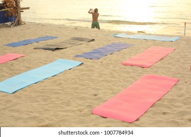 beach yoga lesson preparation with mat on sand and sea background serene photo - Powered by Shutterstock