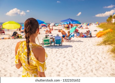 Beach Young Woman Lifestyle Summer Vacation Girl From Behind Relaxing Walking Outside. Brunette With Braid Hair And Yellow Fashion Romper. Fort Myers Beach, Florida