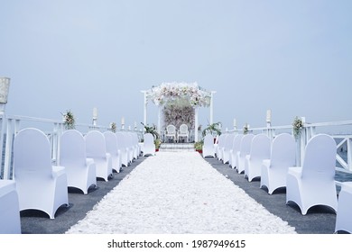 Beachfront Wedding Decoration With White Ornaments And Flowers