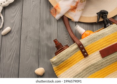 Beachwear Bag Sun Protection Sunglasses Sunscreen Spray Lotion Cream Care Tan Ultra-violet Rays. Summer Background Template Mockup Free Space Pattern Composition Text. Top View Above Wooden Background