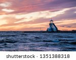 Beacon or lighthouse by the sea at sunset. Location is Nallikari Oulu Finland.