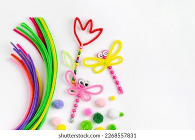 Beaded Pipe Cleaner flowers and dragonflies. Easy spring kids crafts. Different multi-colored supplies and materials for DIY art activity for kids. Children's crafts, creativity and  hobby. 
