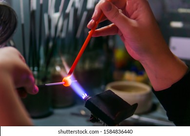 beadmaking - making glass beads manually by the winding method in a glass-blowing workshop using a high-temperature burner

 - Powered by Shutterstock