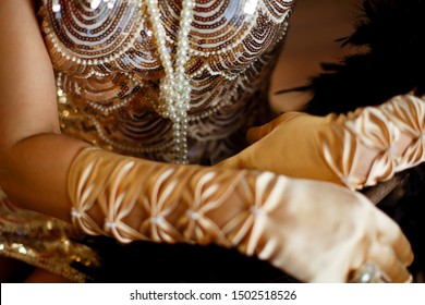 beads of pearls on the background of a dress decorated with sequins - Powered by Shutterstock