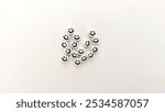 
Beads with smiley faces on a white background, photographed from a top angle