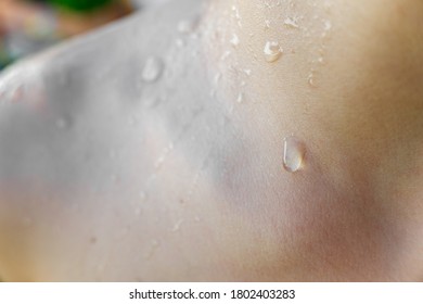 Beads of sweat on the skin of a white child.