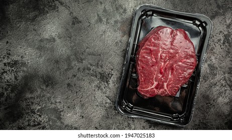 Beaf steak vacuum sealed ready for cooking. . Meat products in packed on black background, meat semi finished product. top view. - Powered by Shutterstock