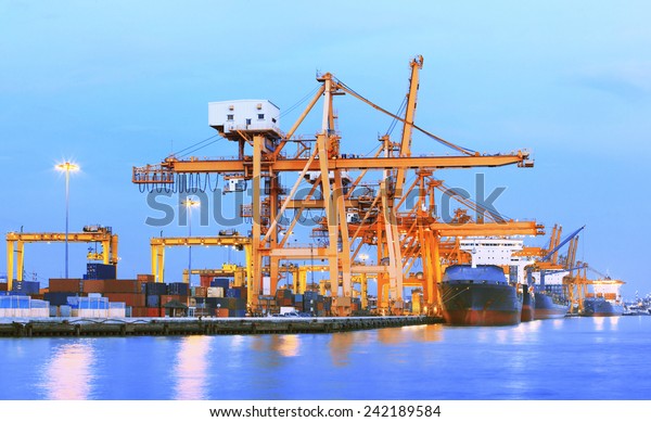 beaitiful landscape of heavy crane tool in ship port and\
container yard use for import - export and freight ,shipping of\
world trading business\
