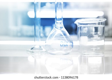 beaker round flask cylinder in research medical science laboratory background - Shutterstock ID 1138096178