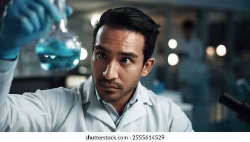 Beaker, science and solution with man in laboratory at night for breakthrough, development or experiment. Chemical reaction, investigation and liquid with scientist at work for innovation or research