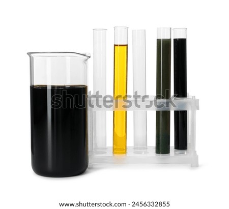 Beaker and test tubes with different types of oil isolated on white