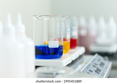 Beaker in various colors on the laboratory mixer.