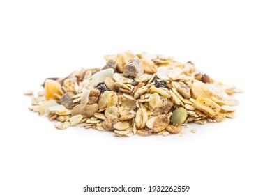 Beakfast cereals in bowl. Healthy muesli with oat flakes, nuts and raisins isolated on white background.