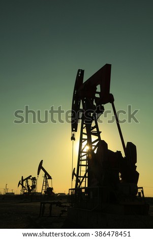 Beam balanced pumping unit under the setting sun in oilfield