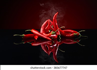 beam of red chilli pepper on black background