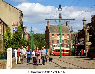 BEAMISH, UK - JULY 27, 2012: Tourists, Tramlines And An Old Tram In The High Street Of The Edwardian Town That Forms Part Of Beamish Museum In County Durham, England.