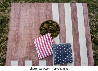 Bean bags on American flag Cornhole board