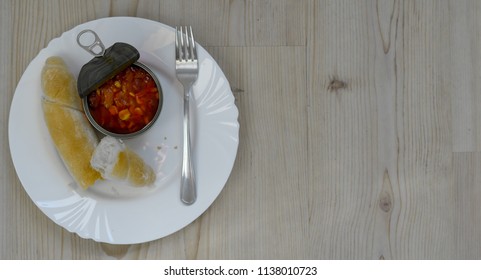 beans with a roll and a fork lying on a plate